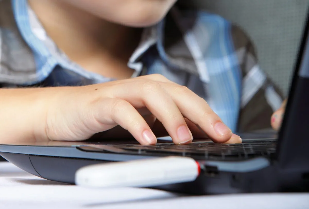 A young boy using a laptop in a file photo. (Illustration/Shutterstock)