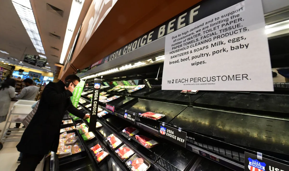 A sign posted announces two-items per customer for certain items as people shop for food at a Ralph's Supermarket in Monterey Park, California, on March 16, 2020. (Frederic J. Brown/AFP via Getty Images)