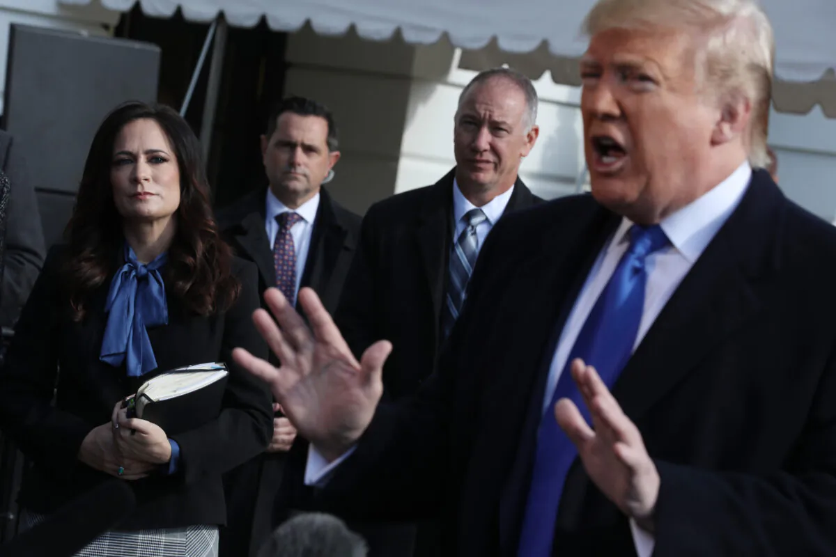 White House Press Secretary Stephanie Grisham, left, listens to President Donald Trump, right, speak outside the White House in Washington on Nov. 8, 2019. (Chip Somodevilla/Getty Images)