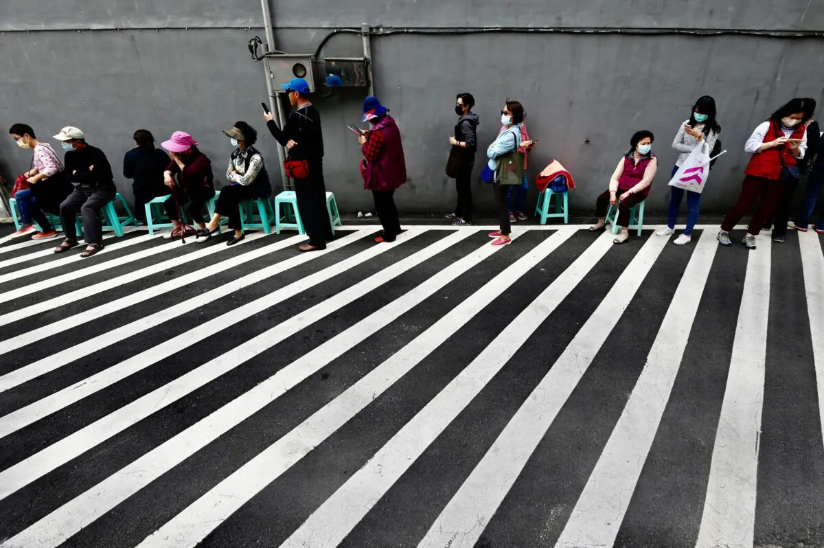 Local residents line up to buy face masks, amid concerns of the COVID-19 coronavirus, from a pharmacy in New Taipei City, Taiwan, on March 17, 2020. (Sam Yeh/AFP via Getty Images)