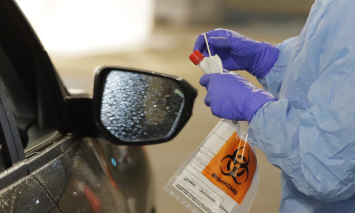 A nurse at a drive-thru coronavirus testing station in Seattle, Washington, on March 13, 2020, (Ted S. Warren/AP Photo)