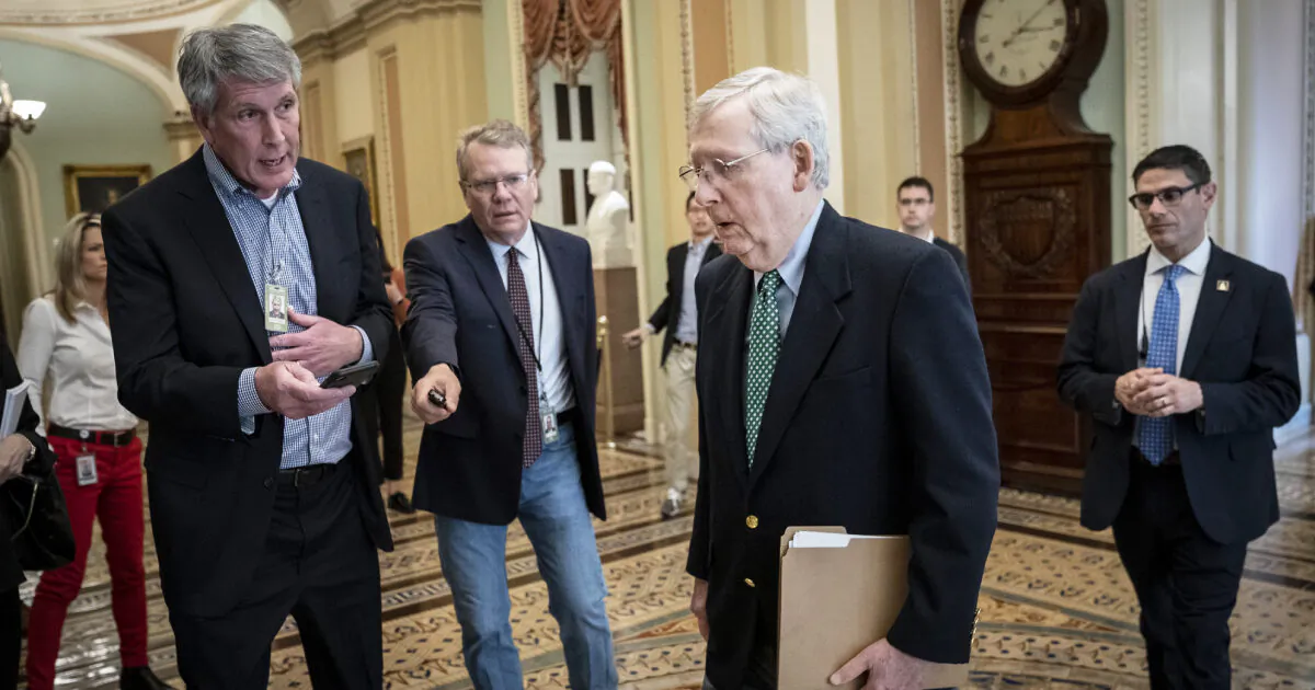 Reporters ask questions as Senate Majority Leader Mitch McConnell (R-Ky.) walks to the Senate floor at the U.S. Capitol in Washington on March 16, 2020. (Drew Angerer/Getty Images)