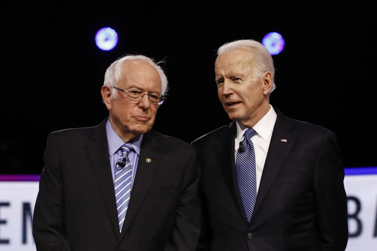 Democratic presidential candidates, Sen. Bernie Sanders (I-Vt.) (L) and former Vice President Joe Biden, talk before a Democratic presidential primary debate in Charleston, S.C., on Feb. 25, 2020. (Matt Rourke/AP Photo)