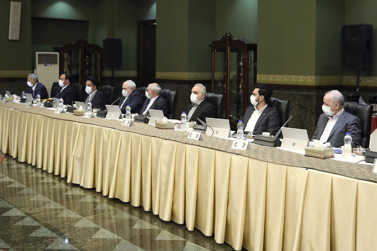 Cabinet members wearing masks attend their meeting in Tehran, Iran, on March 18, 2020. (Office of the Iranian Presidency via AP)