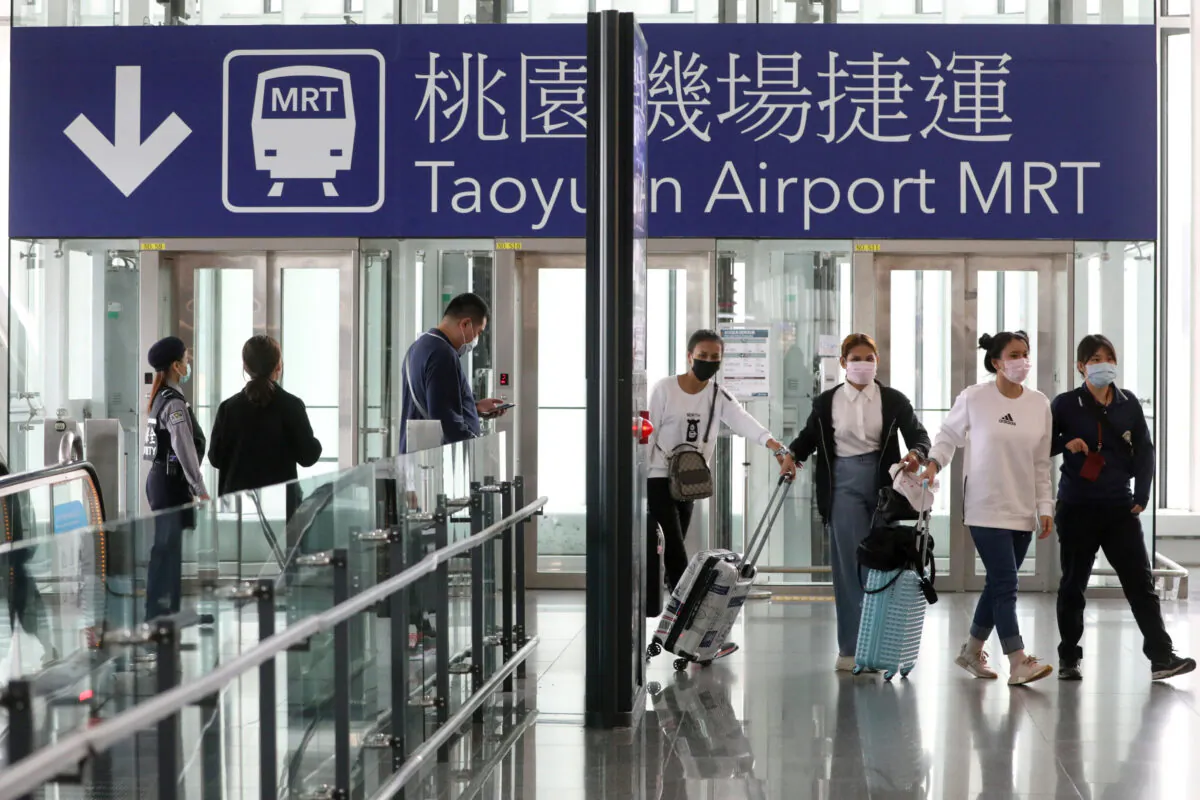 Travelers arrive at the airport as the Taiwanese government announced a ban for most foreigners entering the island, as part of preventive measures against coronavirus disease (COVID-19), at Taoyuan International airport in Taoyuan, Taiwan, on March 18, 2020. (Ann Wang/Reuters)