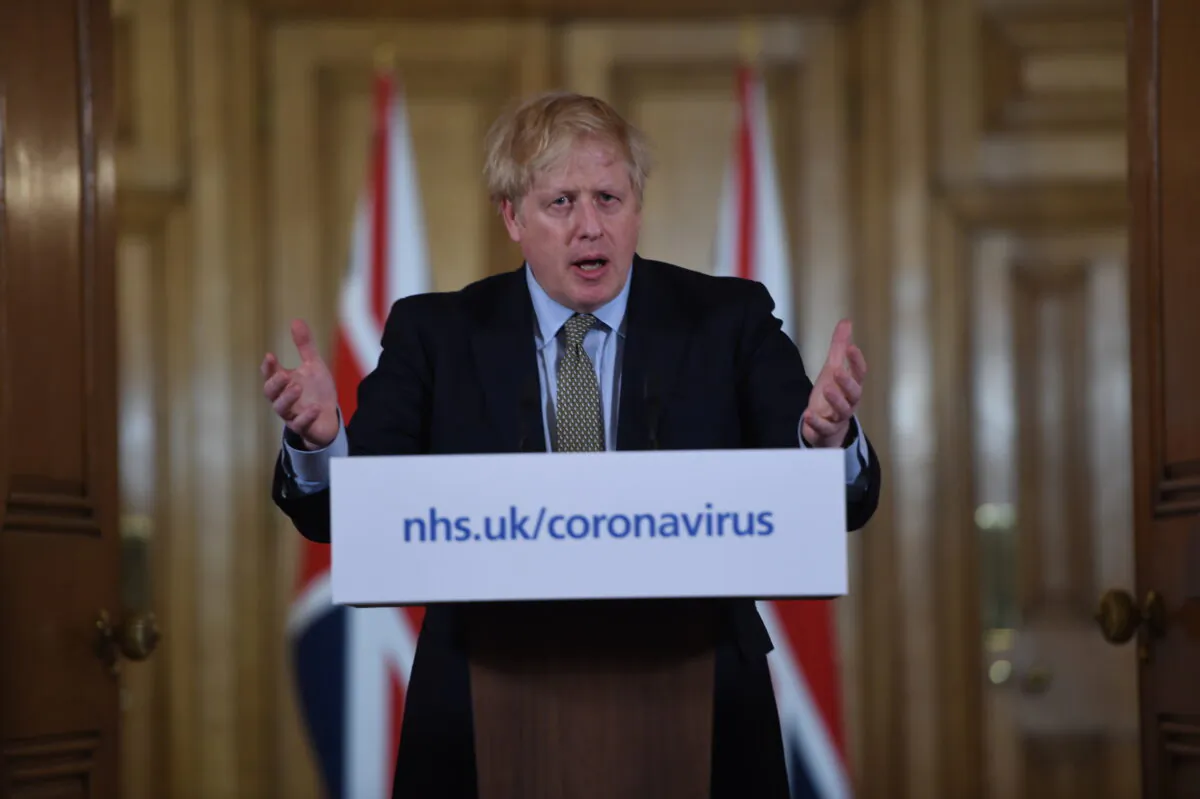 British Prime Minister Boris Johnson gestures as he gives a press conference about the ongoing situation with the COVID-19 outbreak inside 10 Downing Street in London, England, on March 18, 2020. (Eddie Mulholland/WPA Pool/Getty Images)