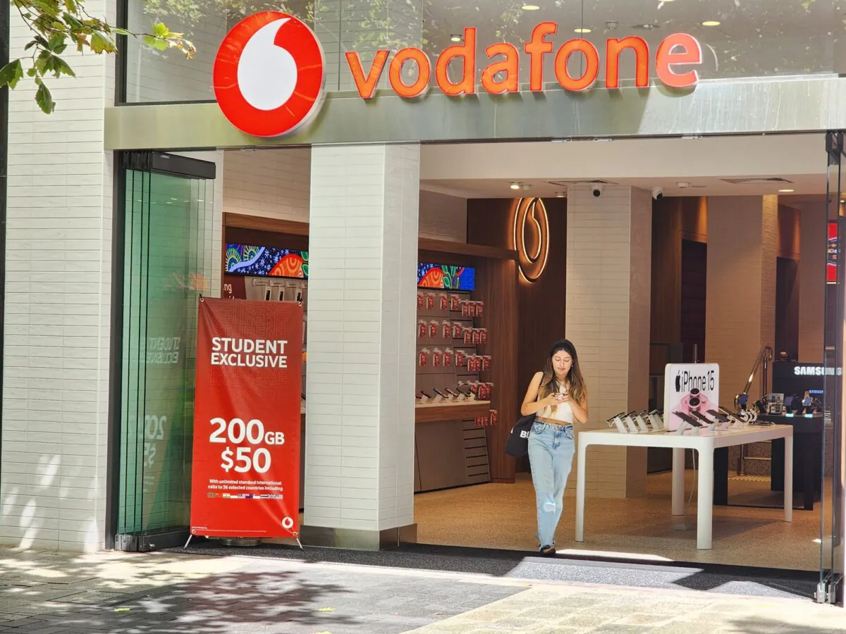 A woman walks out of a Vodafone store in Perth, Western Australia, on March 18, 2024. (Susan Mortimer/The Epoch Times)