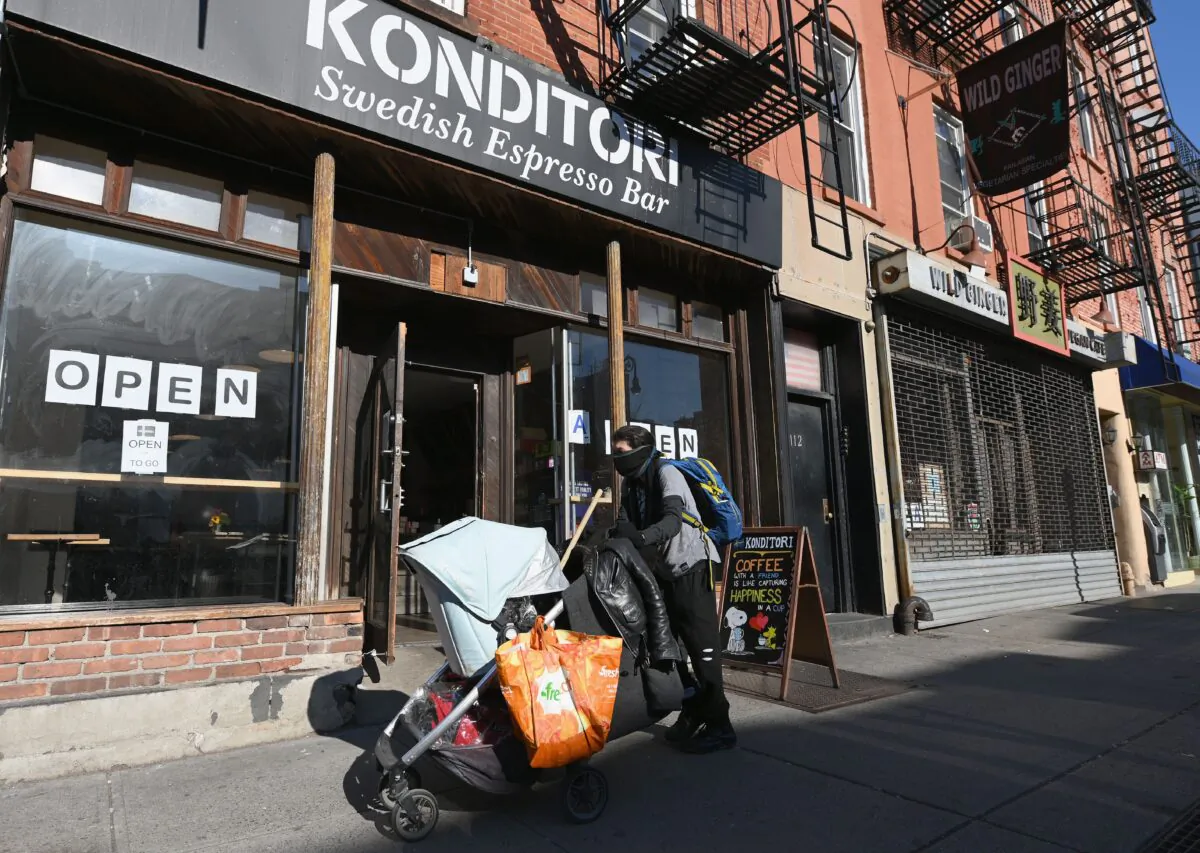 A person walks by a coffee shop in New York City on March 18, 2020. (Angela Weiss/AFP via Getty Images)