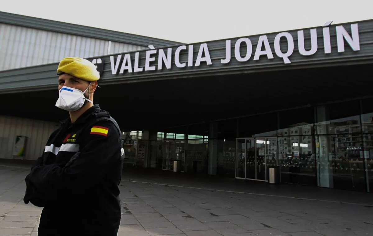Members of the Military Emergencies Unit control access to the Joaquin Sorolla railway station in Valencia, Spain, on March 18, 2020. (Jose Jordan/AFP via Getty Images)