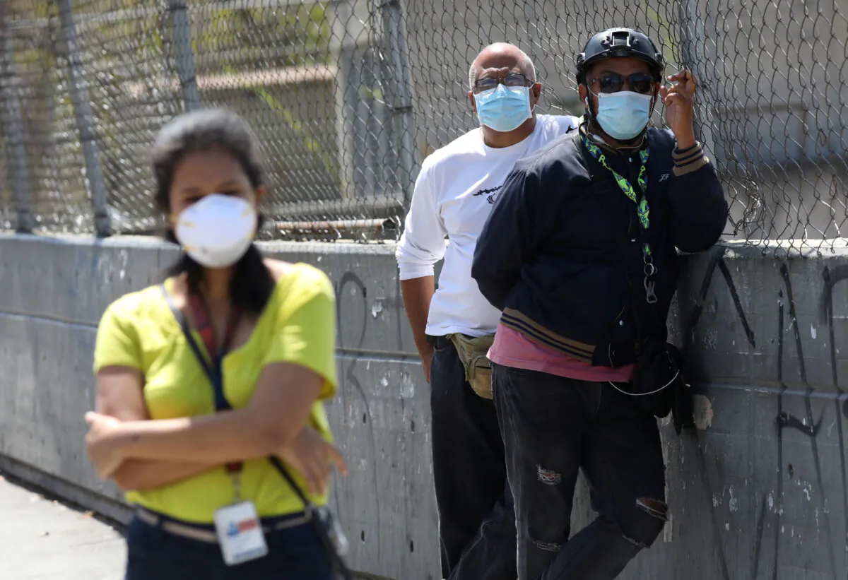 People wearing protective masks on the streets after the start of quarantine in response to the spread of coronavirus disease (COVID-19) in Caracas, Venezuela March 17, 2020. {Manaure Quintero/Reuters)