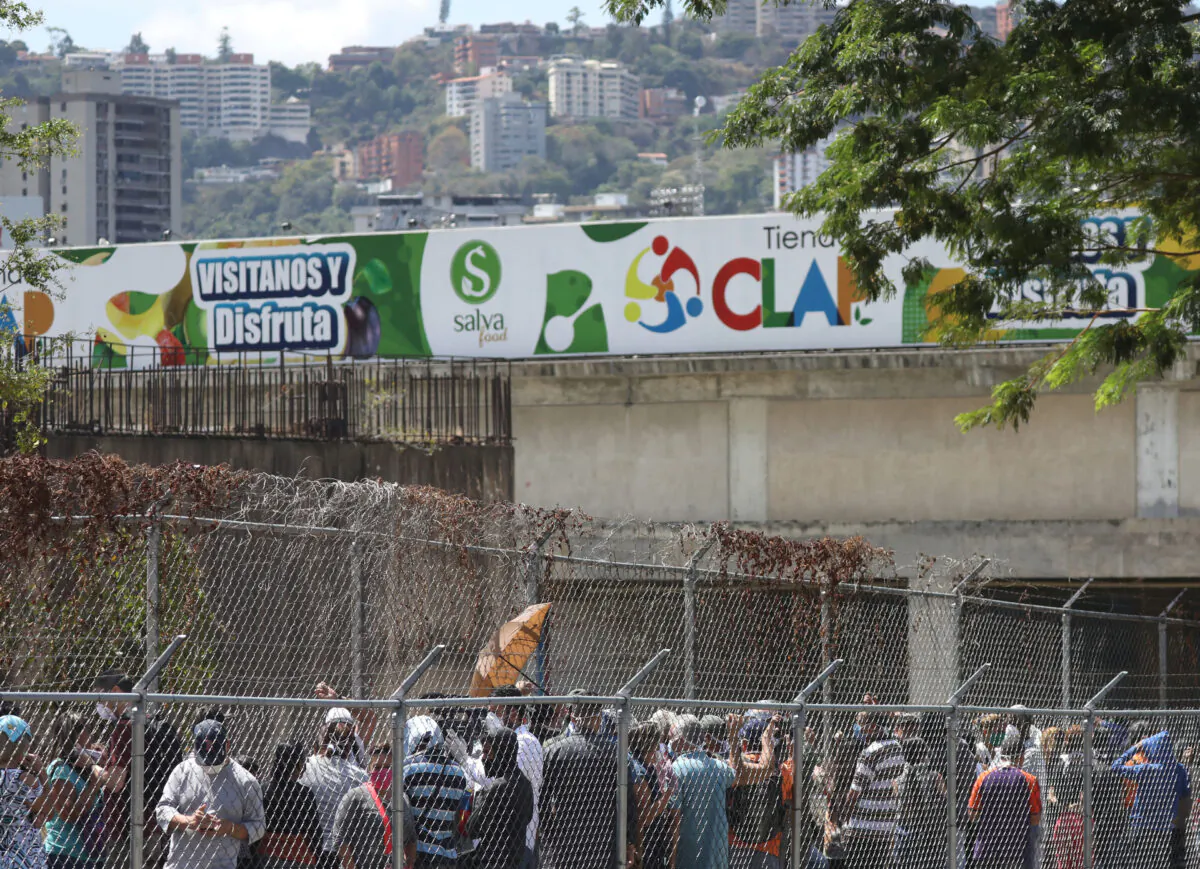 People queue in front of a supermarket during the national quarantine in response to the spreading  CCP virus disease (COVID-19) in Caracas, Venezuela March 17, 2020. (Manaure Quintero/Reuters)
