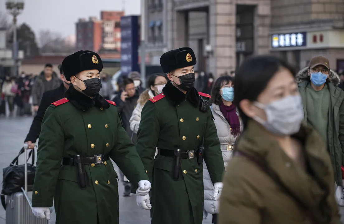 Chinese police officers wear protective masks as they patrol at Beijing Station before the annual Spring Festival on Jan. 22, 2020, in Beijing. (Kevin Frayer/Getty Images)