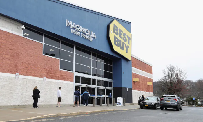 People wait in line at a Best Buy while observing social distancing as customers are allowed to enter a couple at a time while the coronavirus continues to spread across the United States in Huntington Station, N.Y., on March 19, 2020. (Bruce Bennett/Getty Images)