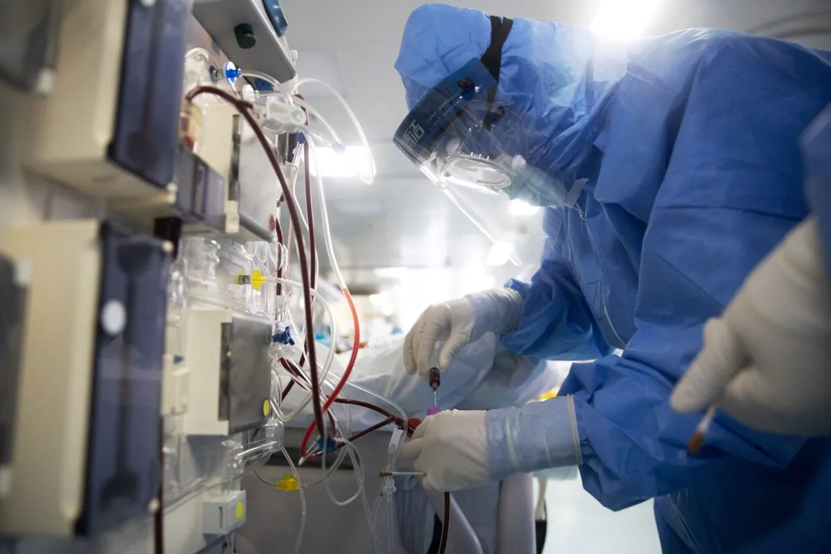 Medical staff check equipment as they treat COVID-19 patients at a hospital in Wuhan, in China's central Hubei province on March 19, 2020. (STR/AFP via Getty Images)