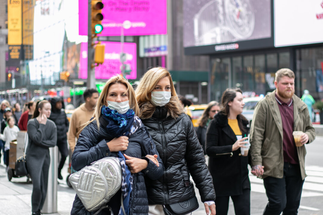 People wear disposable face masks near Times Square, New York, on March 11, 2020. (Chung I Ho/The Epoch Times)