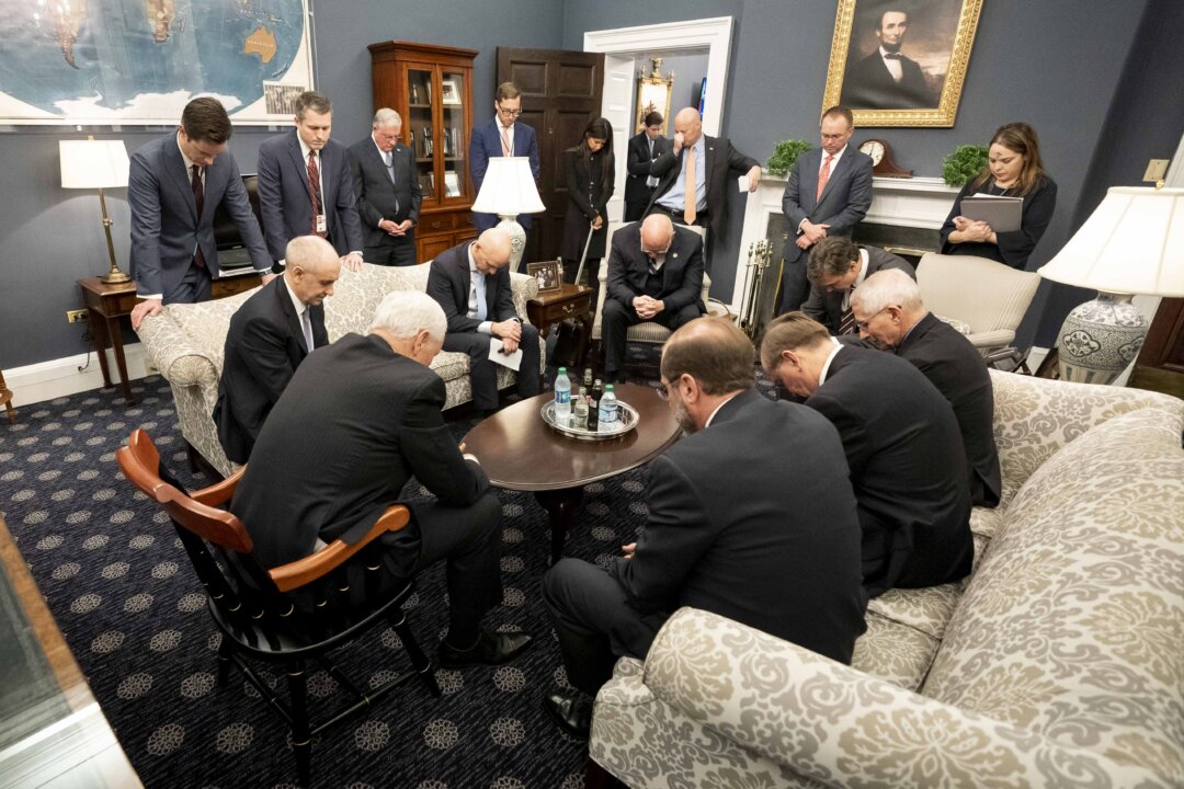 Vice President Mike Pence prays with the President’s Coronavirus Taskforce in his West Wing Office of the White House on Feb. 26, 2020. (Official White House Photo by D. Myles Cullen)