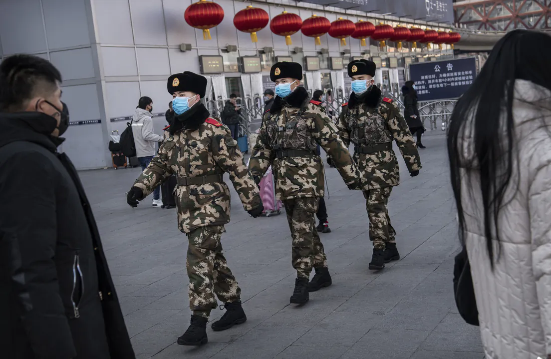 Chinese police officers wear protective masks as they patrol before the annual Spring Festival at a Beijing railway station on Jan. 23, 2020. (Kevin Frayer/Getty Images)