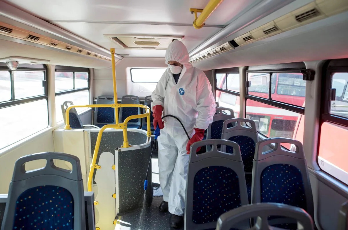 A worker disinfects a public bus against COVID-19 in Skopje, North Macedonia, on Feb. 29, 2020. (Robert Atanasovski/AFP via Getty Images)
