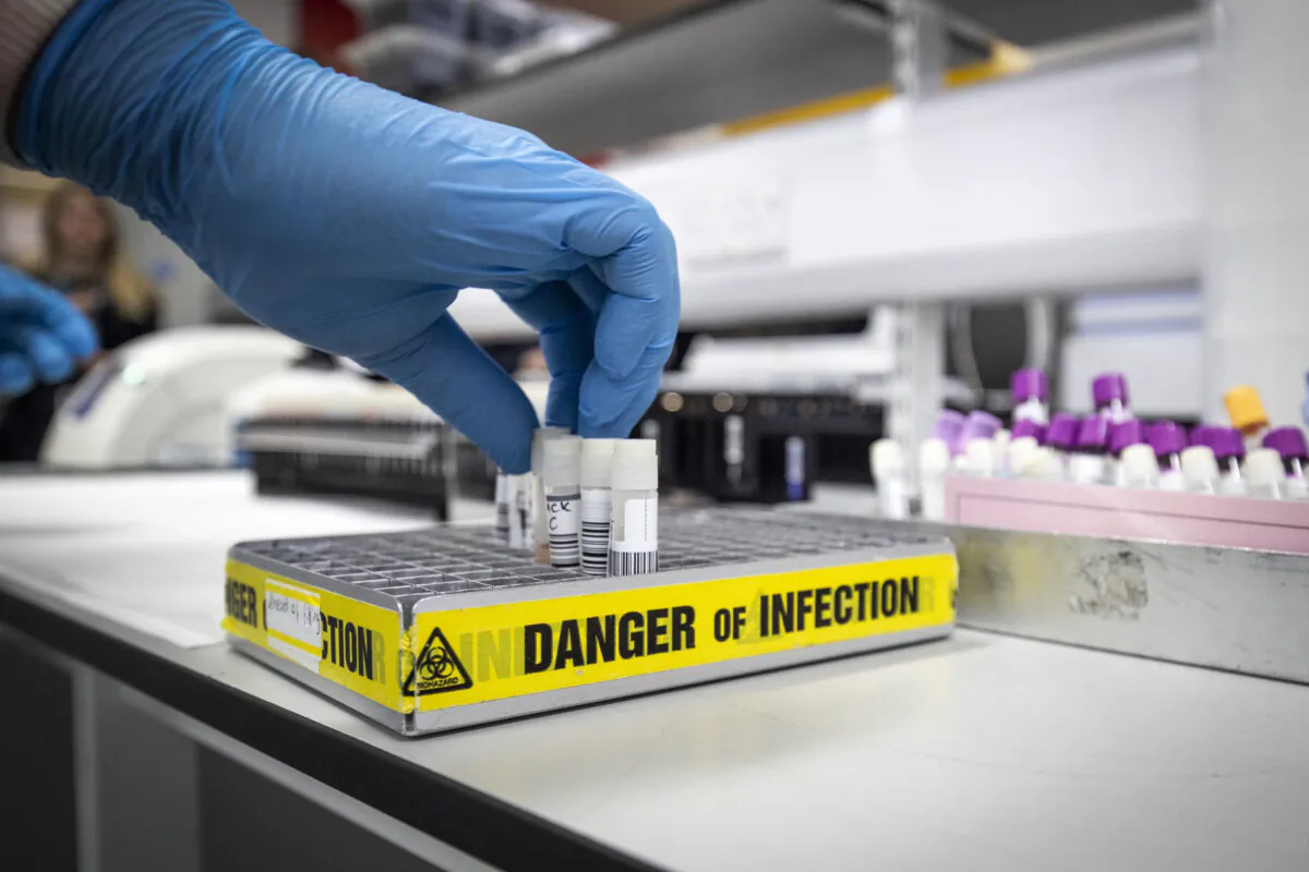 Clinical support technician Douglas Condie extracts viruses from swab samples so that the genetic structure of a virus can be analysed and identified in the coronavirus testing laboratory at Glasgow Royal Infirmary, in Glasgow, Scotland, on Feb. 19, 2020. (Jane Barlow/Getty Images)