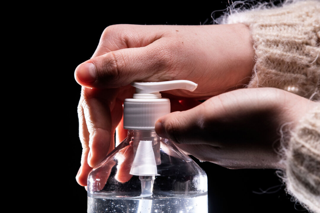 A person uses hand sanitizer in a file photo. (Lionel Bonaventure/AFP via Getty Images)