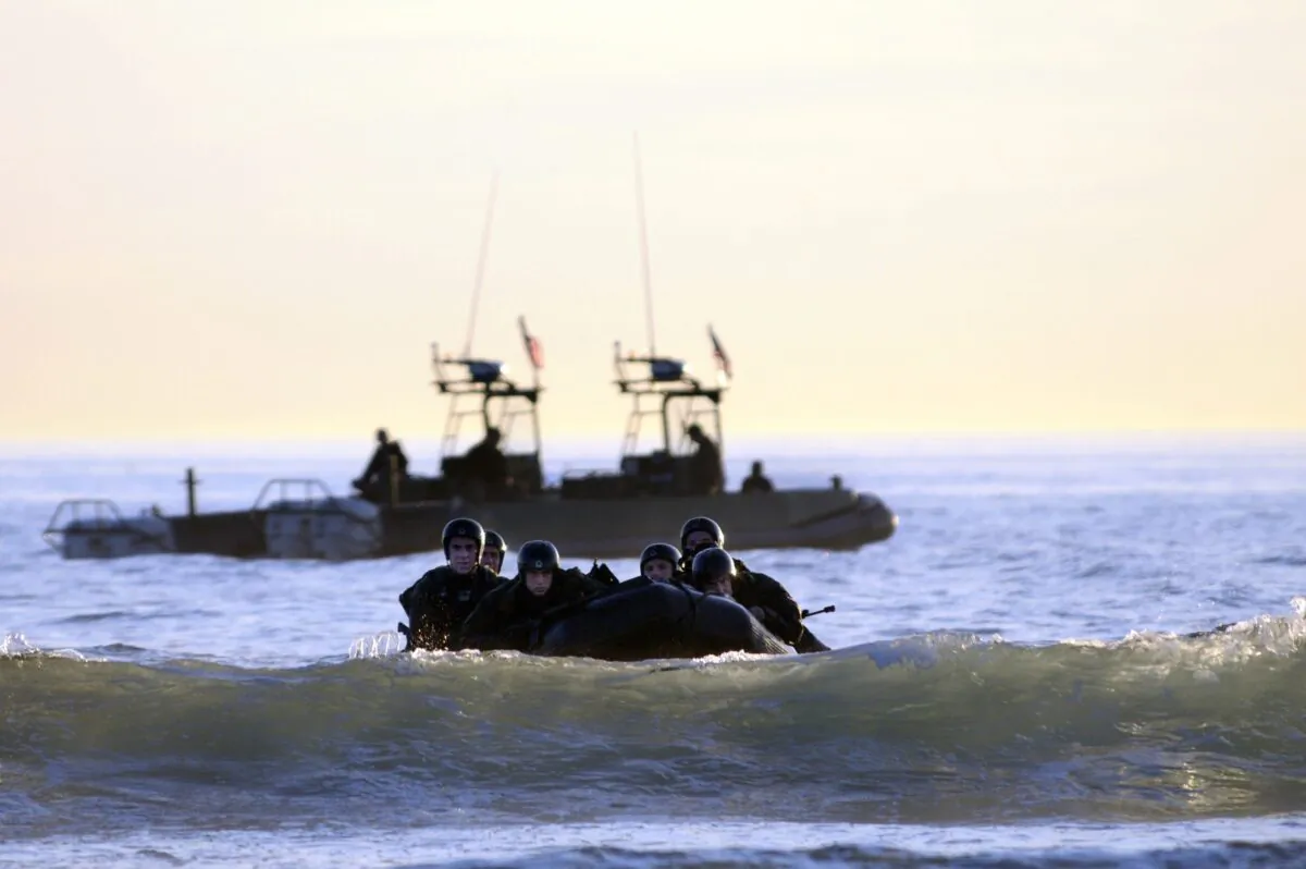 Students in SEAL qualification training navigate the surf during a maritime operations training exercise in Coronado, California, on Oct. 28, 2010 (Blake Midnight/US Navy via Getty Images)