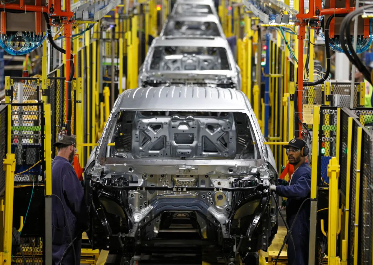 Workers assemble cars at the newly renovated Ford's Assembly Plant in Chicago, June 24, 2019. (Jim Young/AFP via Getty Images)