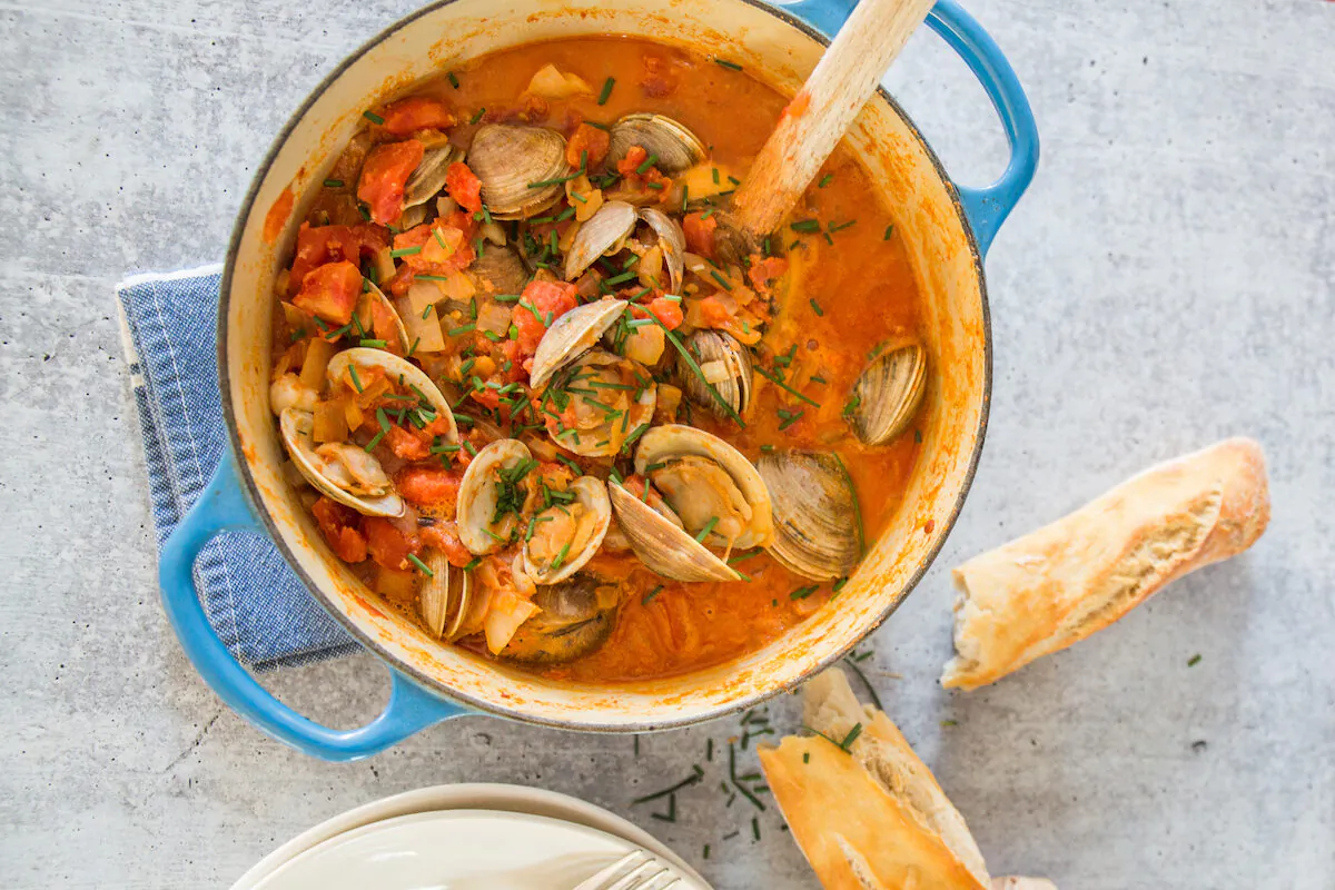 Chorizo, canned tomatoes, and a touch of cream upgrade a basic pot of clams into a satisfying supper. (Caroline Chambers)
