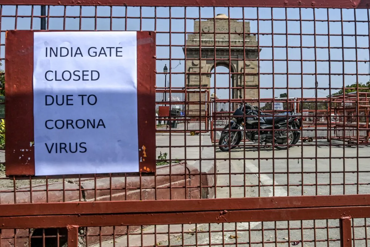 A print-out pasted on a police barricade informs about the closure of the India Gate amid concerns over the spread of COVID-19 novel coronavirus, in New Delhi on March 19, 2020. (Sajjad Hussain/AFP via Getty Images)