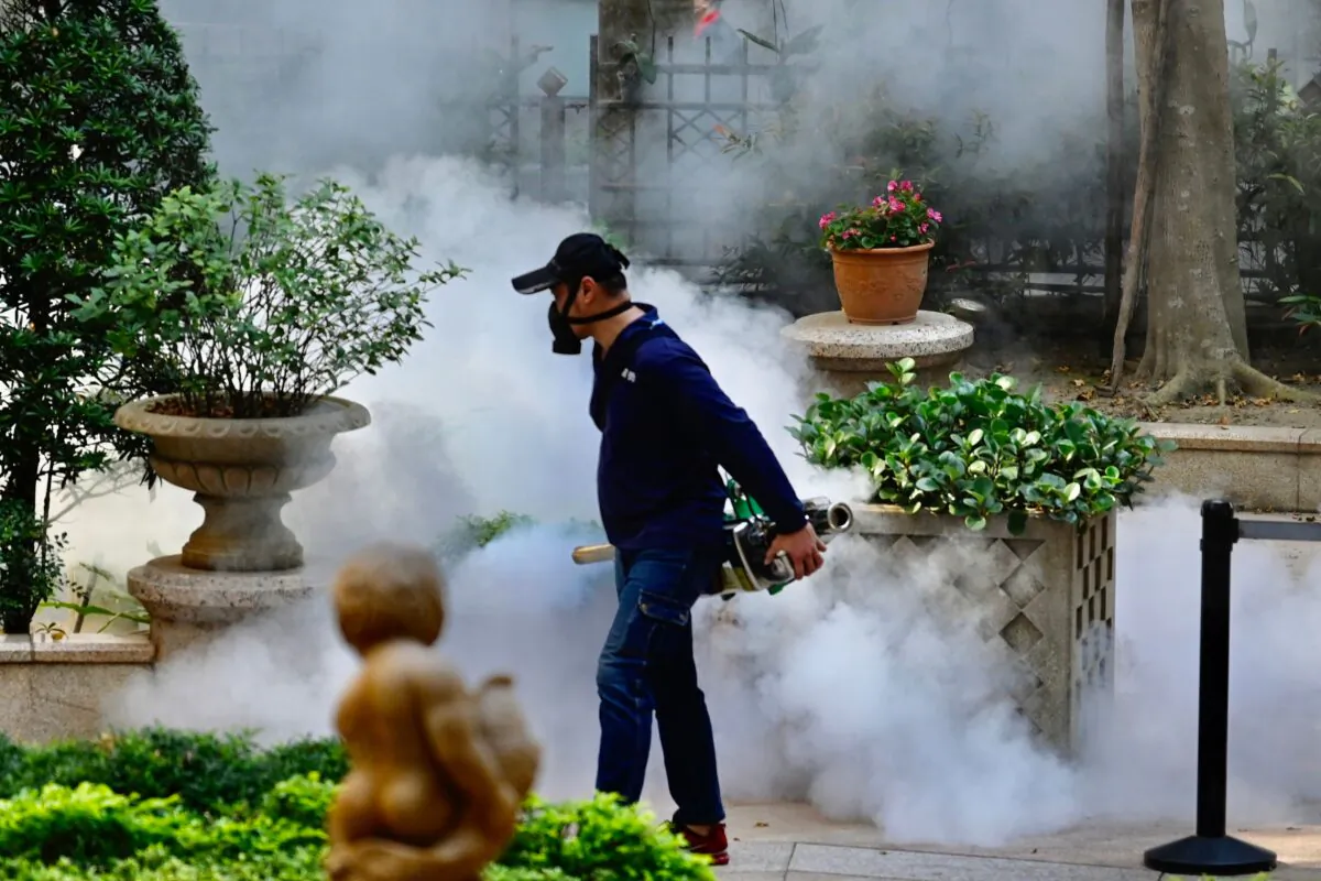 A mask-clad worker disinfects an area in Xindian district in New Taipei City on March 9, 2020. (Sam Yeh/AFP via Getty Images)