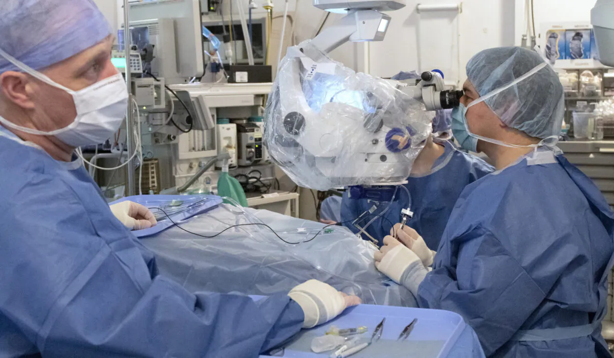 Mark Pennesi, M.D., Ph.D., who leads OHSU's involvement in the trial, center right, looks on as staff at Oregon Health & Science University's Casey Eye Institute perform the first-ever in vivo CRISPR gene edit procedure for the BRILLIANCE clinical trial. The study uses the gene-editing technology CRISPR to repair mutations in the CEP290 gene that cause a rare form of inherited blindness called Leber congenital amaurosis type 10. The trial is sponsored by Allergan plc. and Editas Medicine. (OHSU/Kristyna Wentz-Graff)