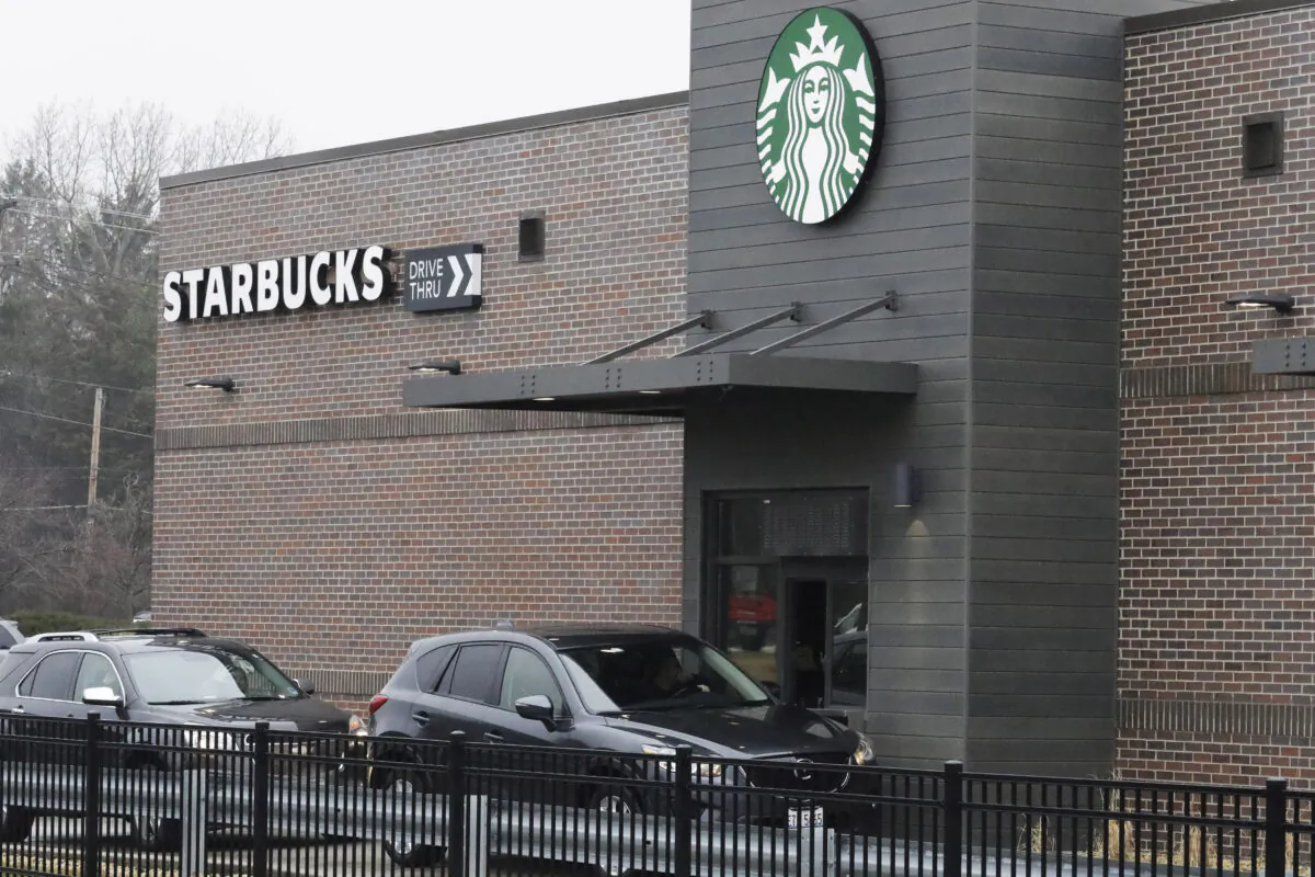Customers wait for their order in their car at a Starbucks in Northbrook, Ill., on March 16, 2020. (Nam Y. Huh/AP Photo)