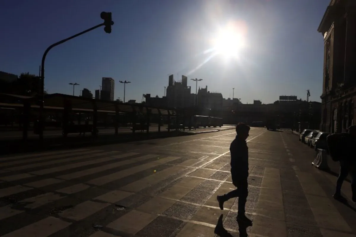 A man is silhouetted while crossing an empty street after Argentina's President Alberto Fernandez announced a mandatory quarantine as a measure to curb the spread of coronavirus disease (COVID-19), in Buenos Aires, Argentina, on March 20, 2020. (Reuters/Matias Baglietto)