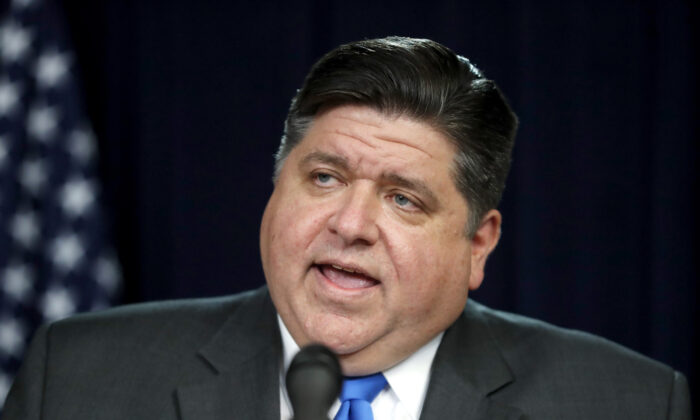 Illinois Gov. J.B. Pritzker, left, announces a shelter-in-place rule to combat the spread of COVID-19, during a news conference in Chicago on March 20, 2020. (Charles Rex Arbogast/AP Photo)
