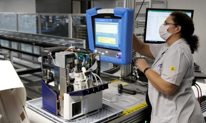 An employee of Hamilton Medical AG tests a ventilator at a plant in Domat/Ems, Switzerland, on March 18, 2020. (Reuters/Arnd Wiegmann/File Photo)