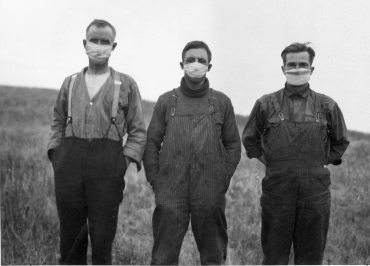 Men in Alberta wearing protective masks during the Spanish flu pandemic of 1918-20. The pandemic killed more than 50,000 people in Canada, most of whom were young adults between the ages of 20 and 40. (CP PHOTO/National Archives of Canada)