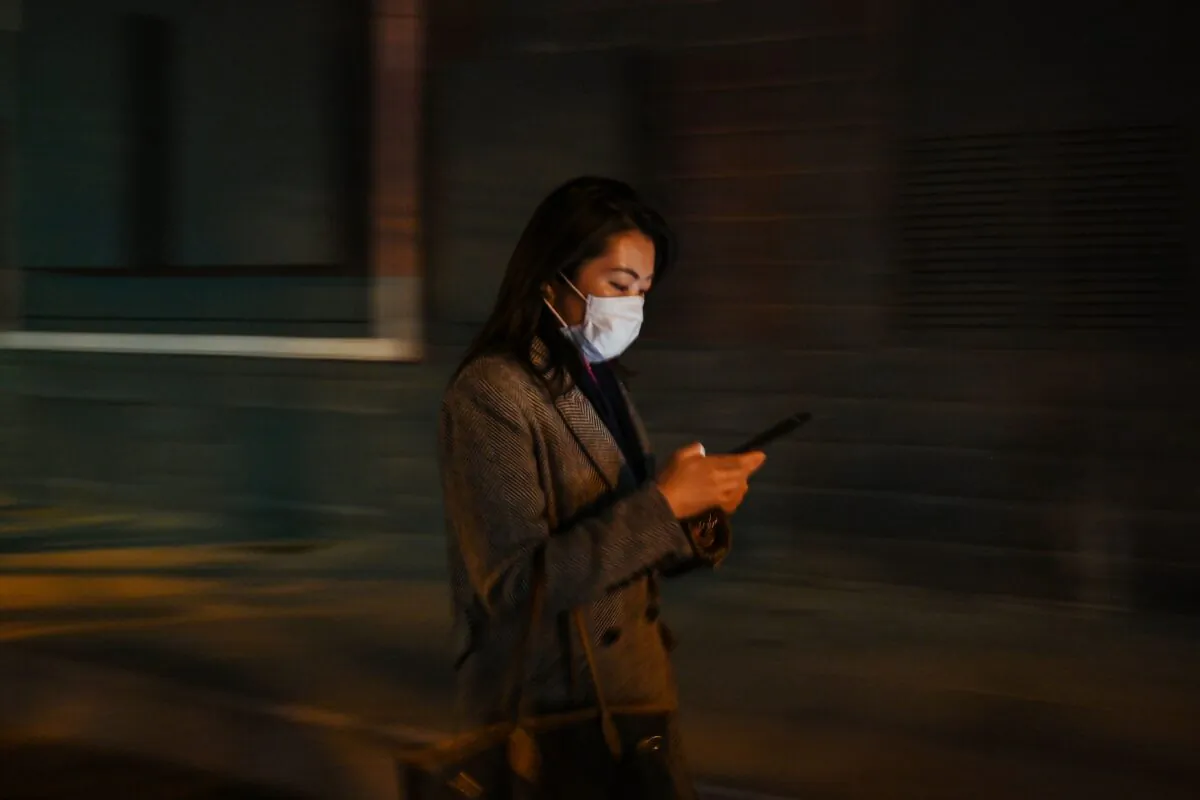 A woman is checking her cell phone in Shanghai, China on March 17, 2020. (HECTOR RETAMAL/AFP via Getty Images)
