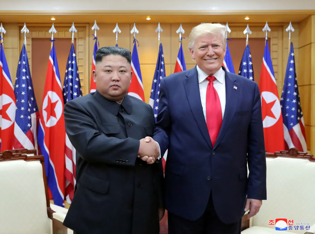 Then-President Donald Trump shakes hands with North Korean leader Kim Jong Un as they meet at the demilitarized zone separating the two Koreas, in Panmunjom, South Korea on June 30, 2019. (KCNA via Reuters)