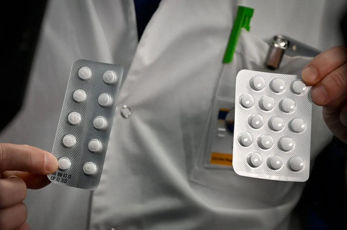 Medical staff shows packets of a Nivaquine, tablets containing chloroquine and Plaqueril, tablets containing hydroxychloroquine at the IHU Mediterranee Infection Institute in Marseille on Feb. 26, 2020. The drugs have shown signs of effectiveness against the CCP virus. (Gerard Julien/AFP via Getty Images)