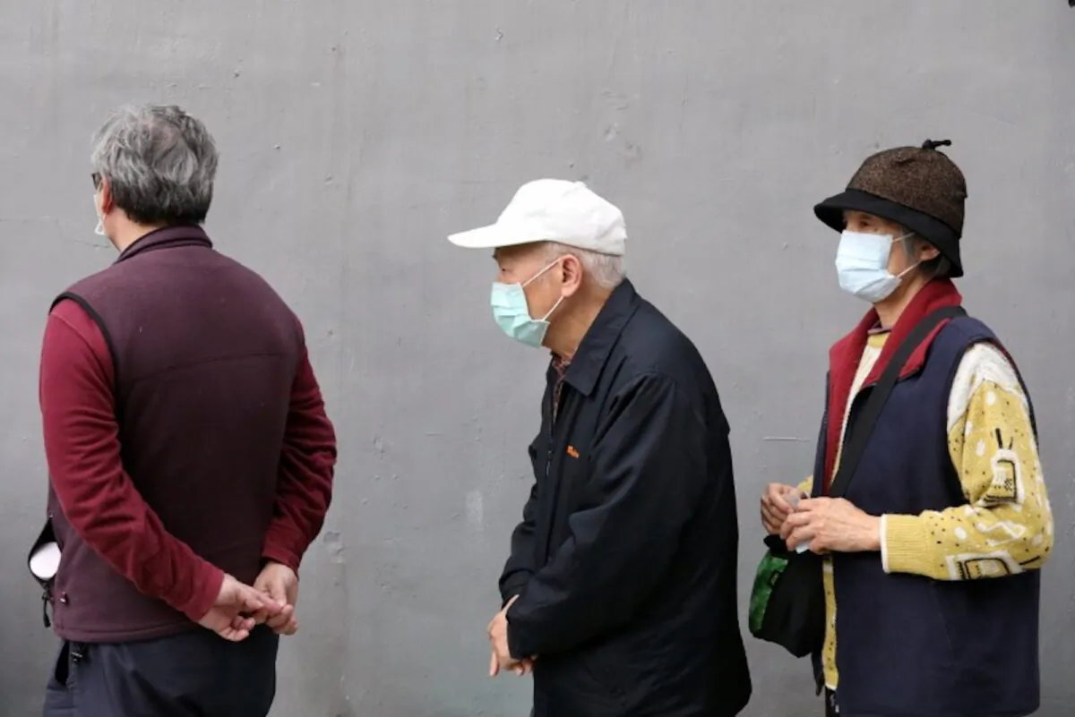 People wait in long lines to buy face masks in order to protect themselves from the coronavirus disease (COVID-19), outside a pharmacy in Taipei, Taiwan, on March 17, 2020. (Ann Wang/Reuters)