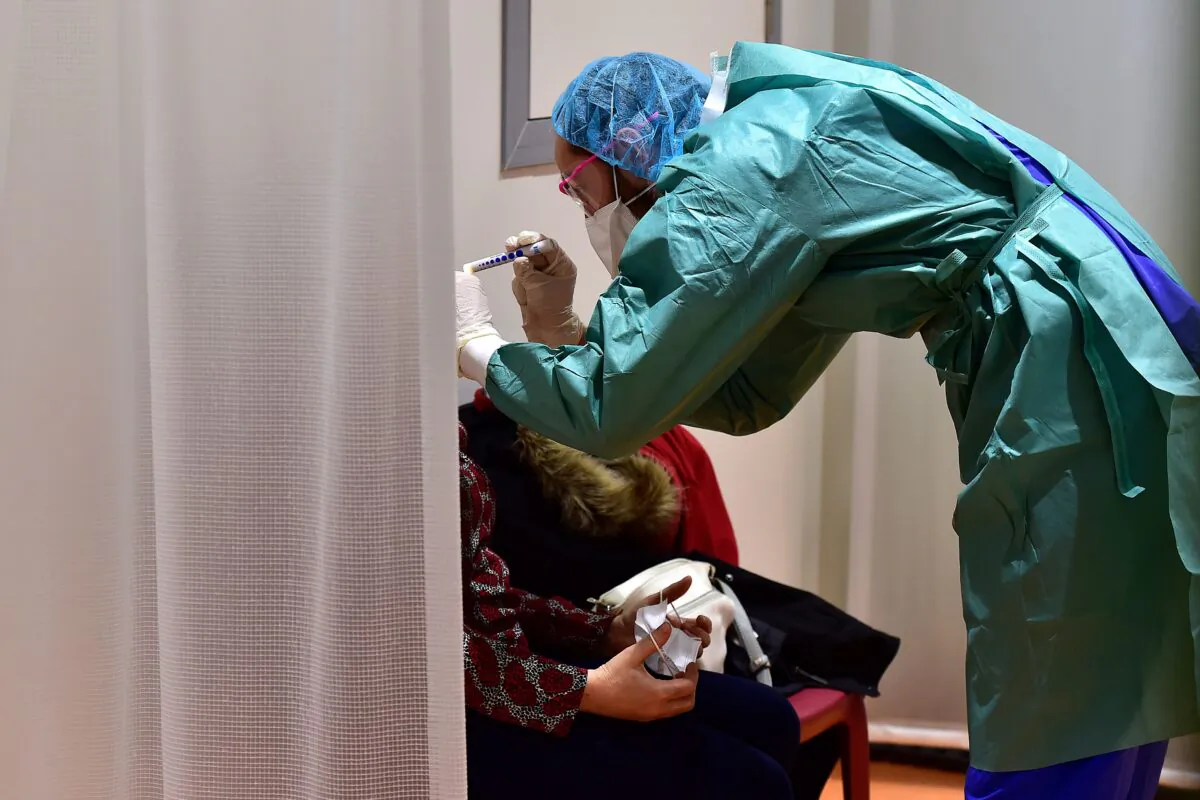 A doctor examines a patient at the hospital screening unit of the CHU Pellegrin in Bordeaux, southwestern France  (Georges Gobet/AFP via Getty Images)