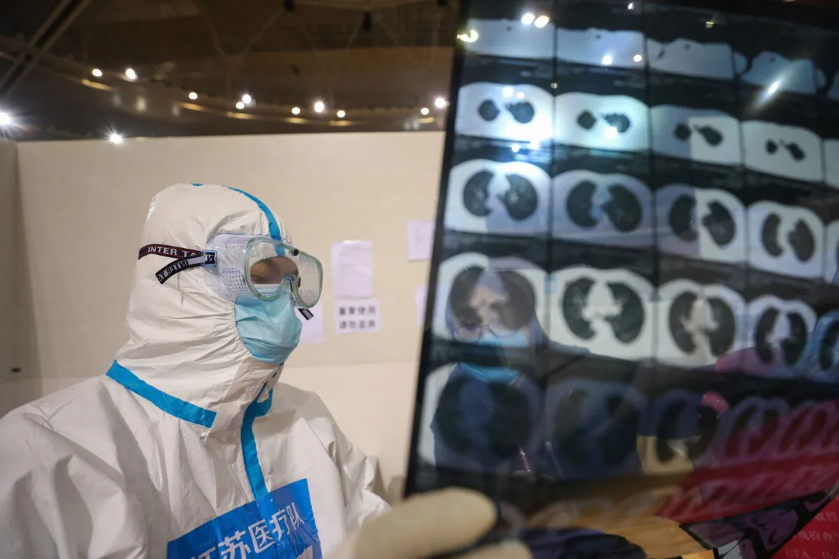 A doctor looking at a patient's CT scan at a temporary hospital in Wuhan, China, on March 5, 2020. (STR/AFP via Getty Images)