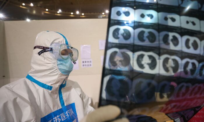 A doctor looking at a patient's CT scan at a temporary hospital in Wuhan, China, on March 5, 2020. (STR/AFP via Getty Images)