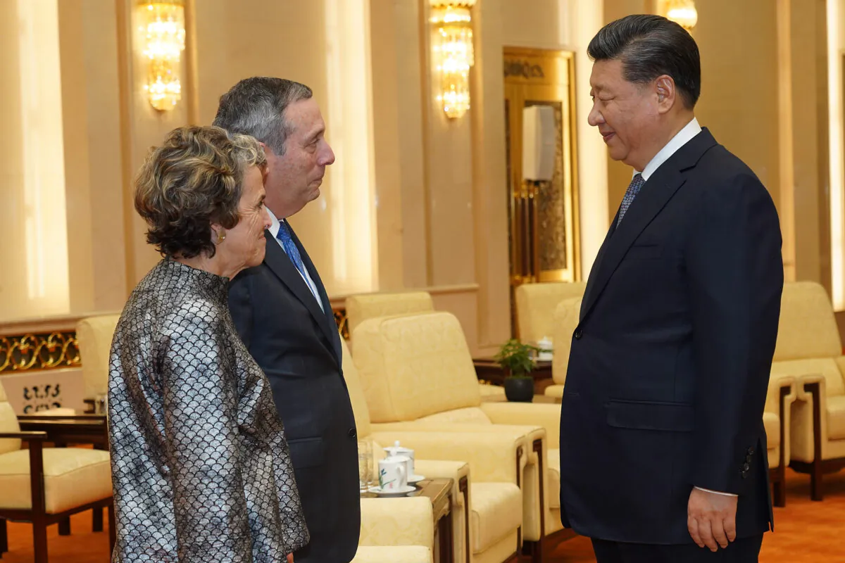 Chinese leader Xi Jinping talks to Harvard University President Lawrence Bacow and his wife Adele Fleet Bacow at The Great Hall of the People in Beijing, China, on March 20, 2019. (Andrea Verdelli/Pool/Getty Images)