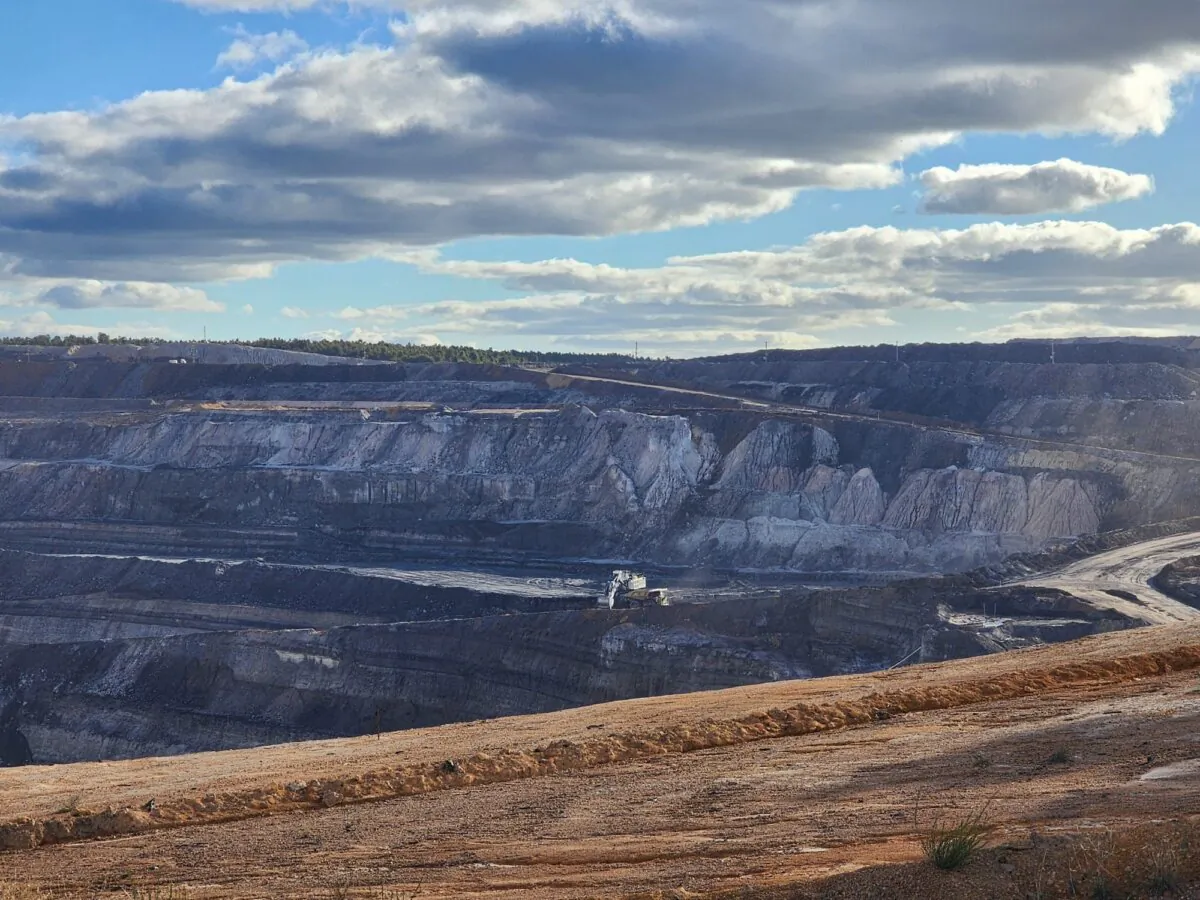 A digger loads a dump truck with coal in an open cut mine owned by Premier Coal in Collie, Western Australia, on June 24, 2024. (Susan Mortimer/The Epoch Times)