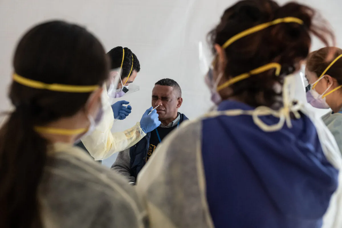 Doctors test hospital staff with flu-like symptoms for the CCP virus in tents set up to triage possible COVID-19 patients outside before they enter the main emergency department area at St. Barnabas hospital in the Bronx borough of New York City on March 24, 2020. (Misha Friedman/Getty Images)