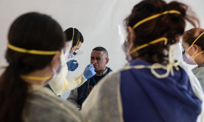 Doctors test hospital staff with flu-like symptoms for the CCP virus in tents set up to triage possible patients outside before they enter the main emergency department area at St. Barnabas hospital in the Bronx borough of New York City on March 24, 2020. (Misha Friedman/Getty Images)