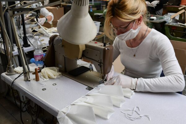 An employee wearing a protective mask