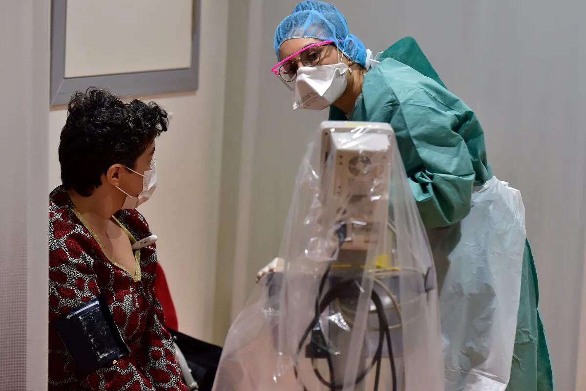 A medical staff member examines a patient at a hospital in Bordeaux, France, on March 9, 2020. (Georges Gobet/AFP/Getty Images)