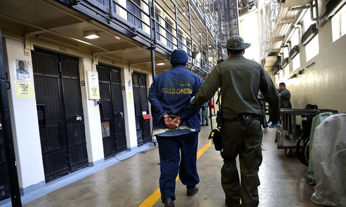An armed California Department of Corrections and Rehabilitation (CDCR) officer escorts a condemned inmate at San Quentin State Prison's death row in San Quentin, Calif., on Aug. 15, 2016. (Justin Sullivan/Getty Images)