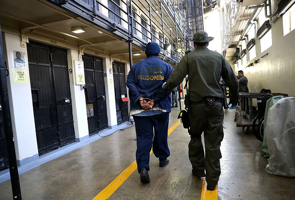 An armed California Department of Corrections and Rehabilitation (CDCR) officer escorts a condemned inmate at San Quentin State Prison's death row in San Quentin, Calif., on Aug. 15, 2016. (Justin Sullivan/Getty Images)